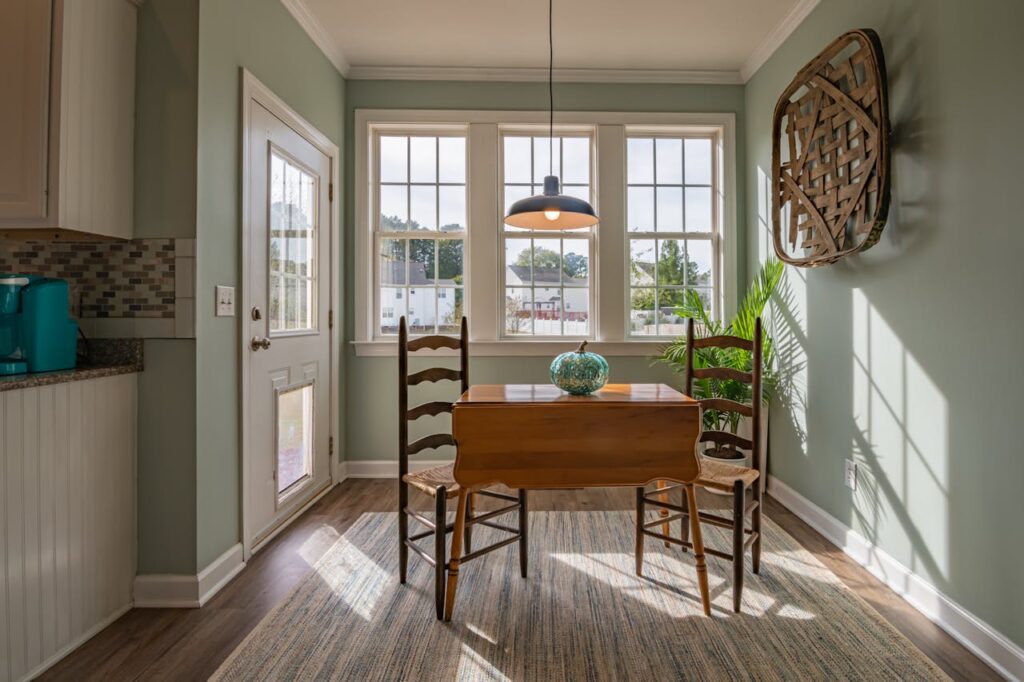 The Art of Drawing Readers In: Your attractive post title goes here Bright dining area with wooden furniture and large windows showcasing natural light.