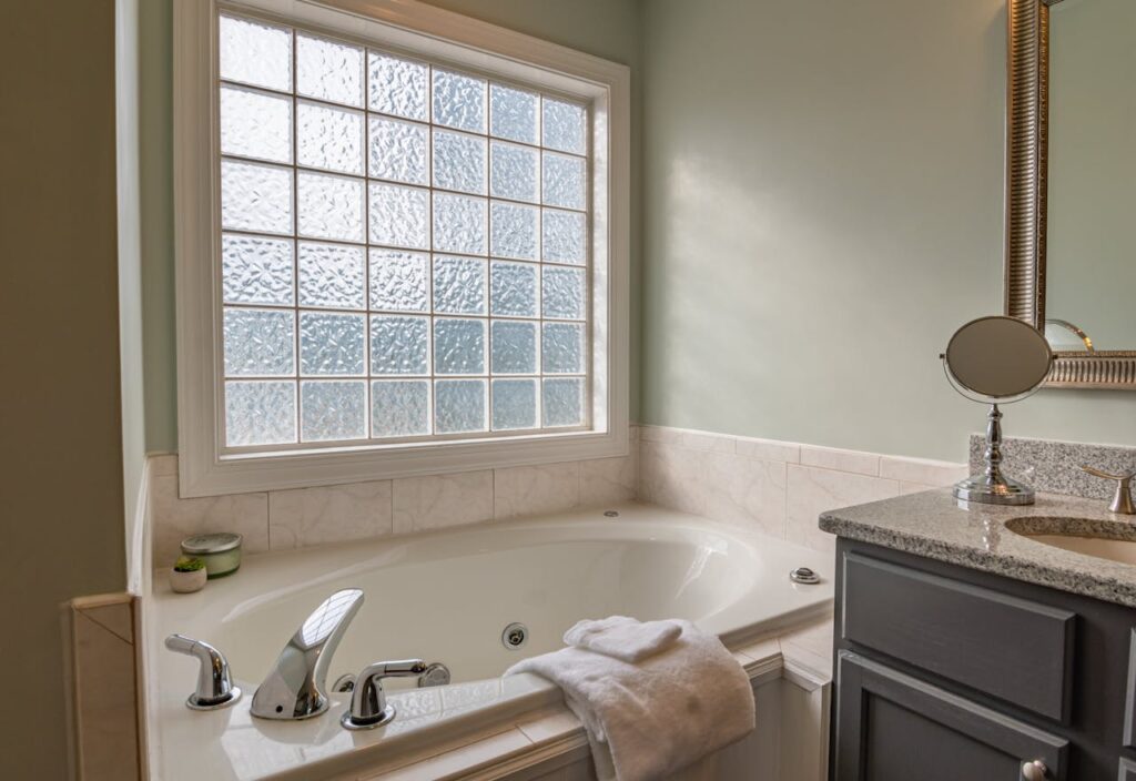 Mastering the First Impression: Your intriguing post title goes here Stylish modern bathroom featuring a luxury bathtub, sleek sink, and large window. Perfect for relaxation.